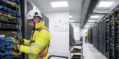 Engineer installing roadside ANPR and telecoms infrastructure